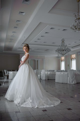 Fototapeta premium Beautiful bride in wedding dress before wedding ceremony