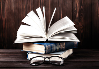 Old books on wooden background. The source of information. Books indoor. Home library. Knowledge is power