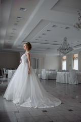 Fototapeta premium Beautiful bride in wedding dress before wedding ceremony