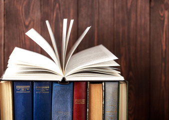 Old books on wooden background. The source of information. Books indoor. Home library. Knowledge is power
