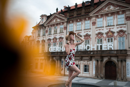 Woman standing in a flower dress at old town square in prague, czech replic