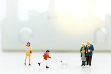 Miniature family: Boy is running with dog. Image use for Family day.
