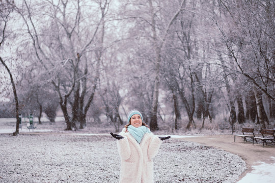 Smiling young woman in snowing outdoor