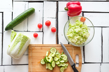 Vegetables lie on a table on a chopping board