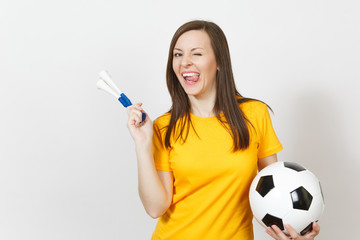 Beautiful European young cheerful happy woman, soccer fan or player in yellow uniform holding football pipe, ball isolated on white background. Sport, play football, health, healthy lifestyle concept.