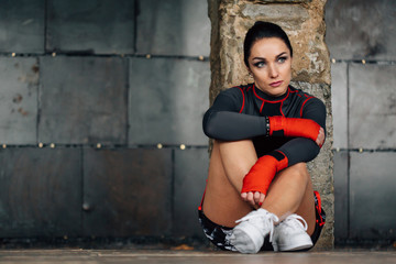 Close up portrait of a young  sportswoman. Pretty female brunete boxer. Healthy lifestyle concept. Cute  girl fighter resting after workout. Woman's day