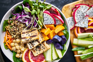 colorful buddha bowl with grilled tofu and dragon fruit
