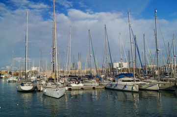 Fototapeta na wymiar Sailing ships and yachts moored in Port of Barcelona, Spain