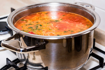 Freshly made borscht in saucepan close