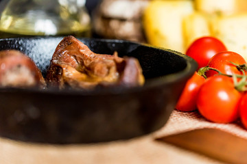 Tasty roasted chicken giblets in pan