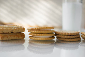 miscellaneous cookies, next to milk on a soft light background