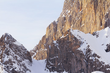 rocky mountain wall with snow