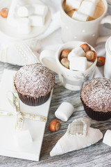 Cups with cacao and marshmallow, cupcakes and different decorations