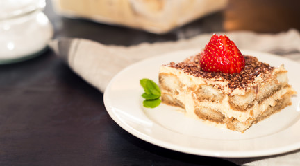 tiramisu cake decorated with strawberries Italian cuisine, Selective focus