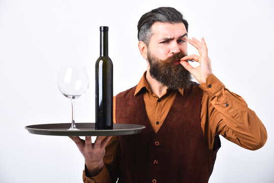 Barman serves red wine showing perfect taste sign.