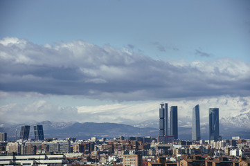 Fototapeta premium Madrid Skyline from the air, snowy in the background mountains