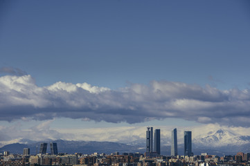 Madrid Skyline from the air, snowy in the background mountains