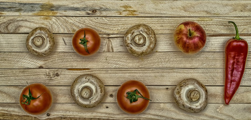 Fresh fruit. Mushrooms, tomatoes, peppers and Apple on a wooden table.