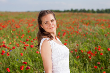 Fototapeta na wymiar Girl in poppy field