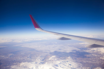 Fototapeta premium Wing aircraft in altitude during flight