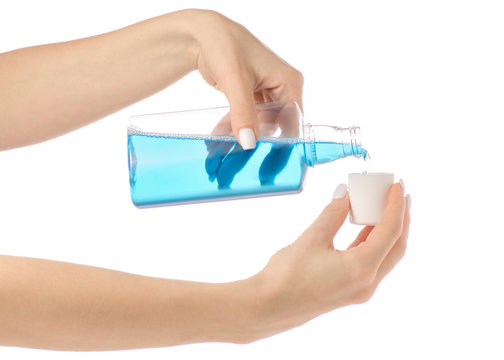 Plastic Bottle With Blue Mouthwash Liquid In Hand