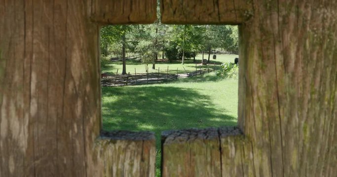 Looking Through Hole in Colonial Wooden Fence at Forest 10bit, 4K