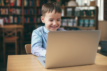 Boy typing on the laptop