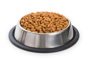 Round metal stainless steel bowl with dried food for pets, animals isolated on white background.