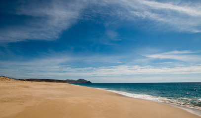 Beach under cirrus cloudscape at the Todos Santos artist community in Baja California Mexico BCS