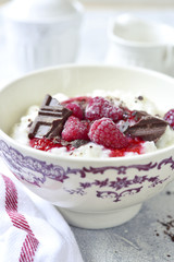 Rice porridge or pudding with berry syrup for a breakfast.