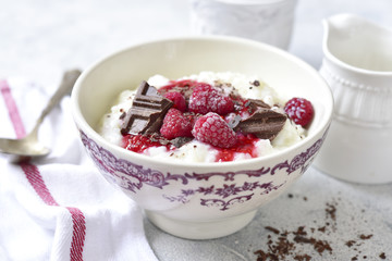Rice porridge or pudding with berry syrup for a breakfast.