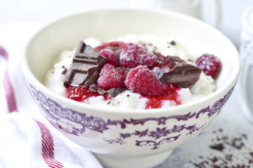 Rice porridge or pudding with berry syrup for a breakfast.