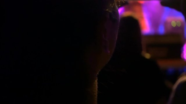 Young woman Making with smartphone video during concert