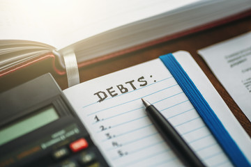 Budget planing concept. Calculating of bills, taxes, credits, payments and debts, paperwork with notebooks and calculator for expenses and finance