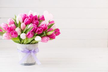 Pink tulip on the white background. Easter background