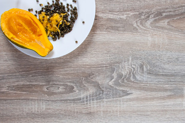 pieces of papaya in white plate on white background