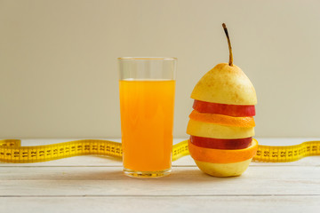 Measure tape and fresh fruit on wooden table. Healthy lifestyle diet with fresh fruits.