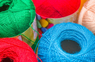 Close up of colorful wool yarn balls in a blurred background