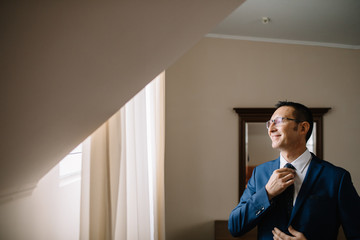 Dressing groom and preparing for ceremony