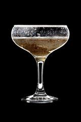 Champagne glass on black background.