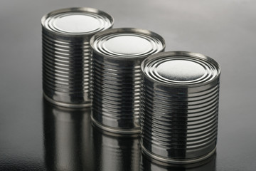 Closeup various metal tin can on black background