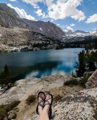 Girl Wearing Sandals Sitting by Lake
