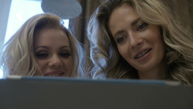Woman shows her girlfriend baby's photo