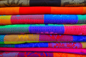 Close up of colorful Mexican blankets for sale at market, Latin America, fabric background