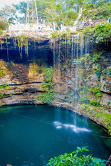 Fototapeta na wymiar Ik-Kil Cenote near Chichen Itza, Mexico. Lovely cenote with transparent waters and hanging roots