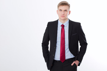 Serious businessman in black suit and red tie isolated on white background. Business concept. Copy space and mock up