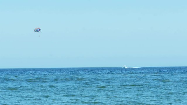 Parasailing From Boat in Ocean High Up