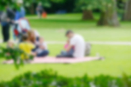 Blurred image of young family with children