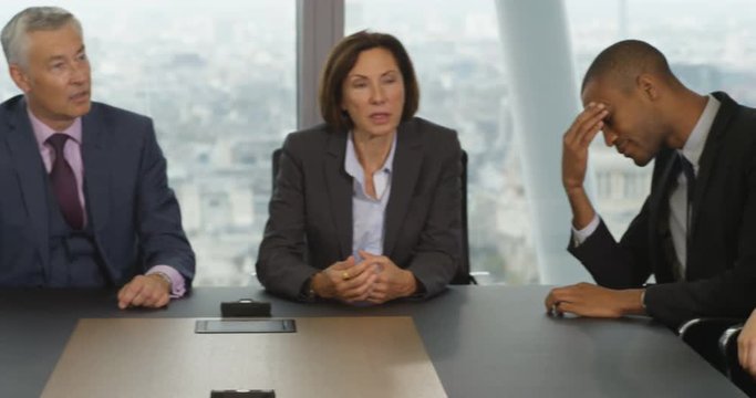 4k, A team of suit-clad business people having a heated debate in boardroom meeting. Slow motion.