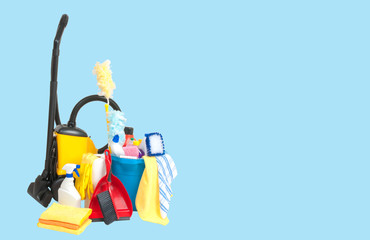 Variety of cleaning products in  bucket  and vacuum cleaner